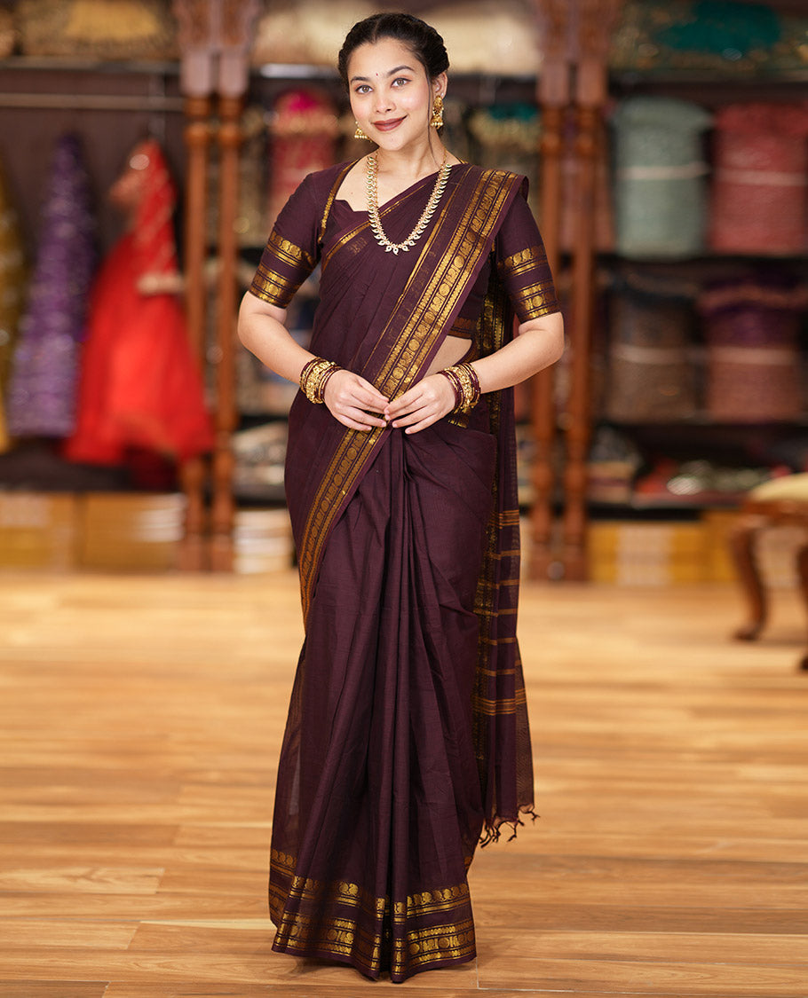Coffee Brown Plain Chettinad Cotton Saree Graced with a Gleaming Zari Rettai Pettu Border Featuring Peacock, Rudraksham, and Neli Designs, Subtly Striped Pallu, and Paired with a Matching Blouse