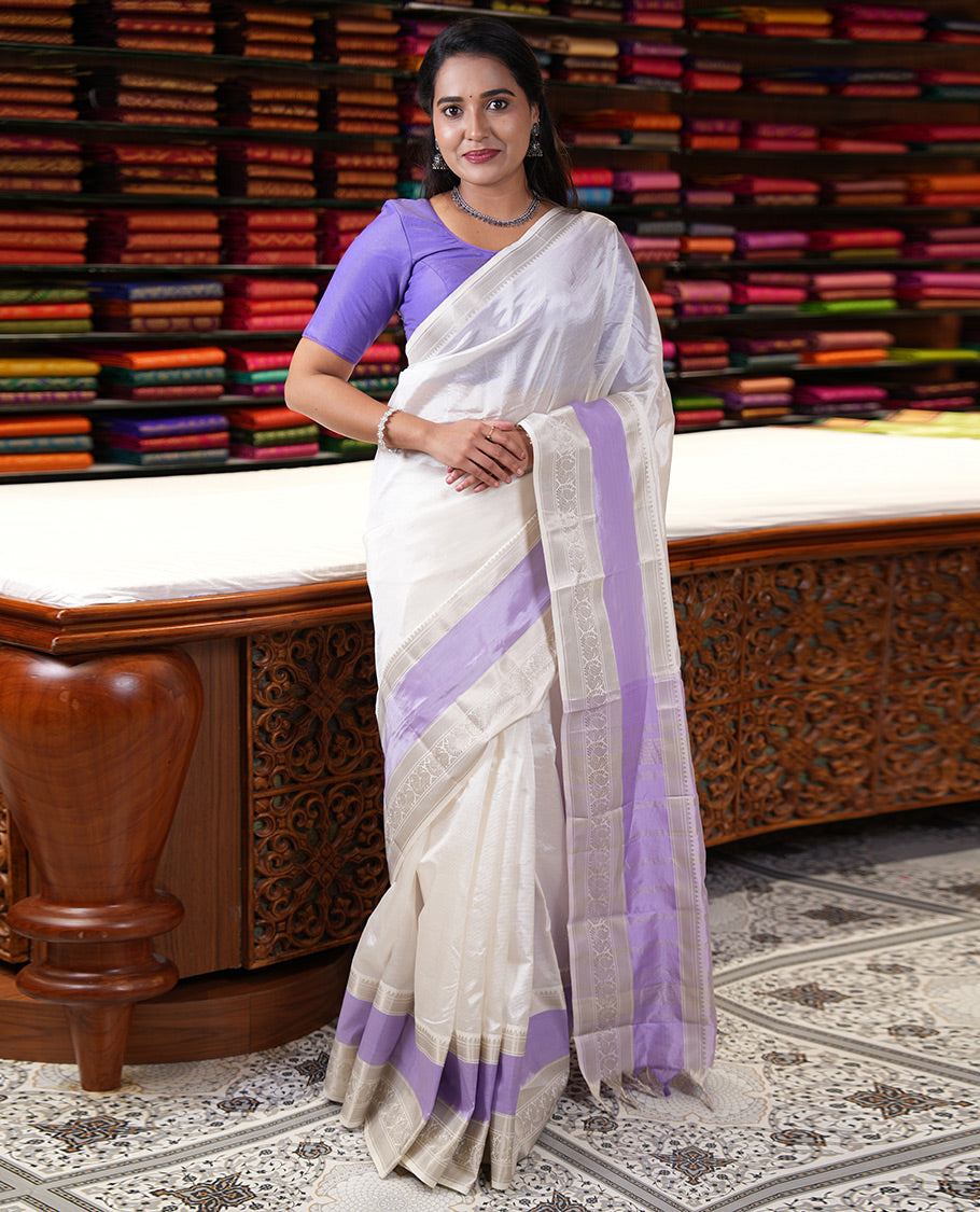 Off-White and Lavender Mangalagiri Silk Saree, Sparsely Woven Stripes on Its Body, Complemented by Contrast Border of Temple and Peacock Designs, Striped Pallu, and Paired with a Contrast Blouse