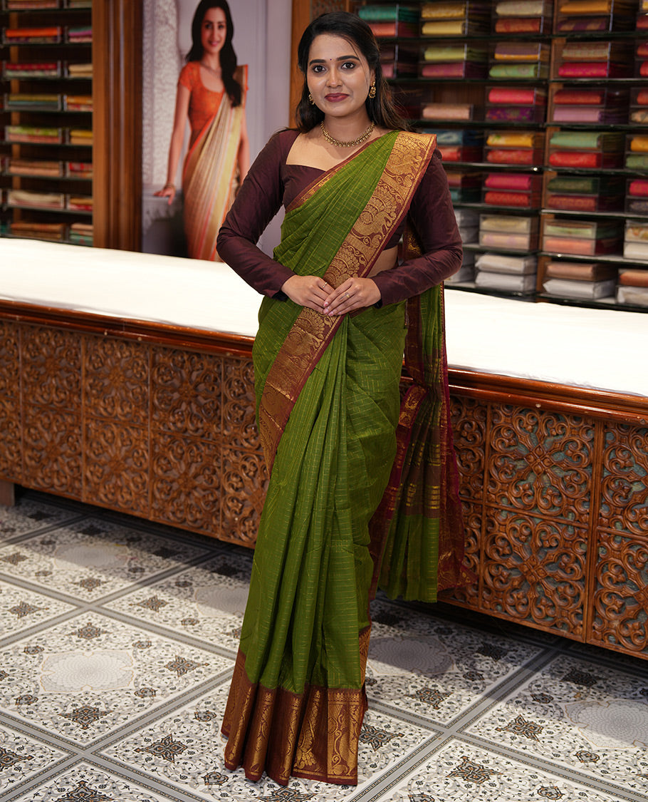 Olive Green Chettinad Cotton Saree, Gleamed Up Checked Design All Over Its Body, Complemented by a Contrast Traditional Zari Border of Peacock Designs, Zari-Striped Pallu, and Has No Blouse