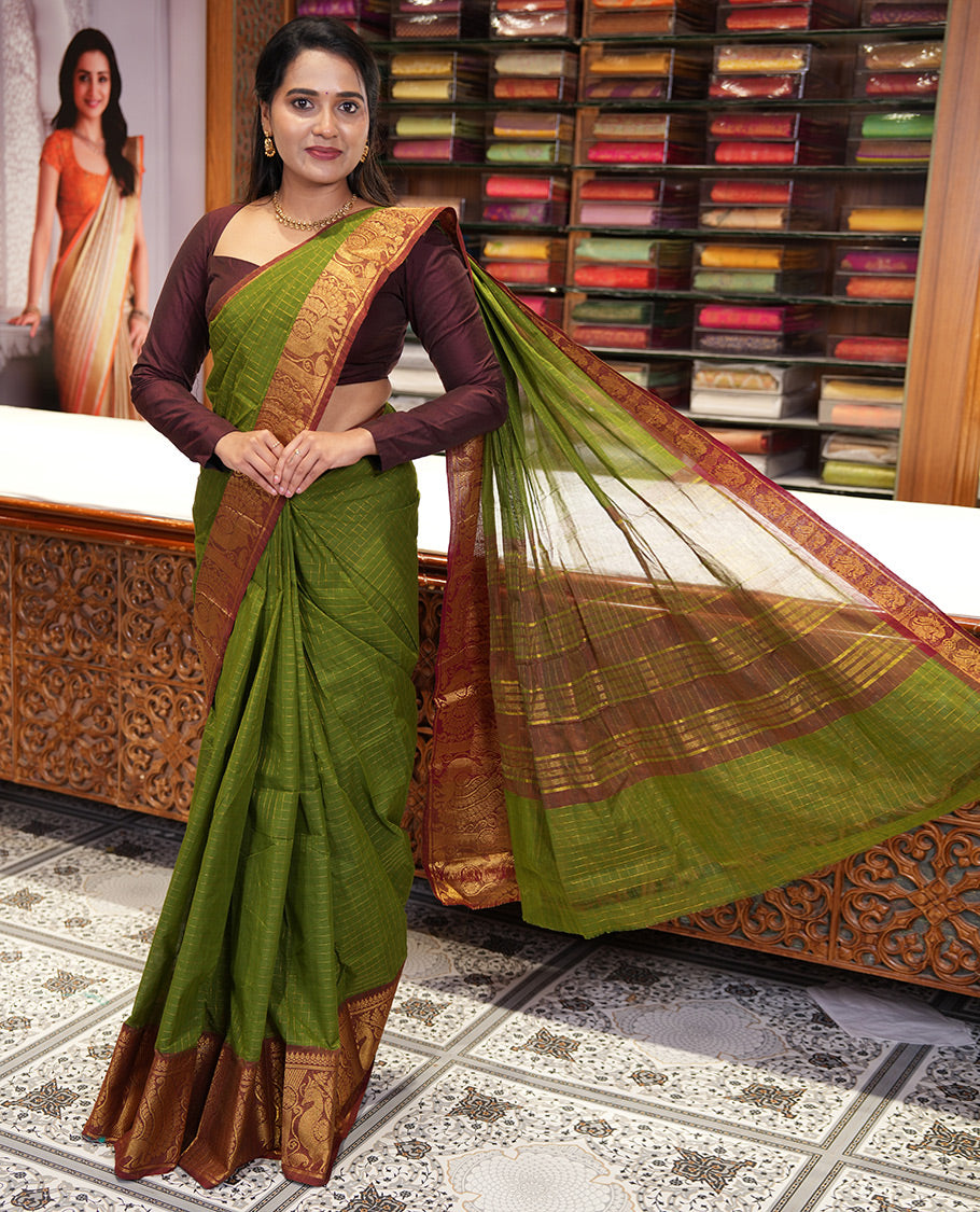 Olive Green Chettinad Cotton Saree, Gleamed Up Checked Design All Over Its Body, Complemented by a Contrast Traditional Zari Border of Peacock Designs, Zari-Striped Pallu, and Has No Blouse