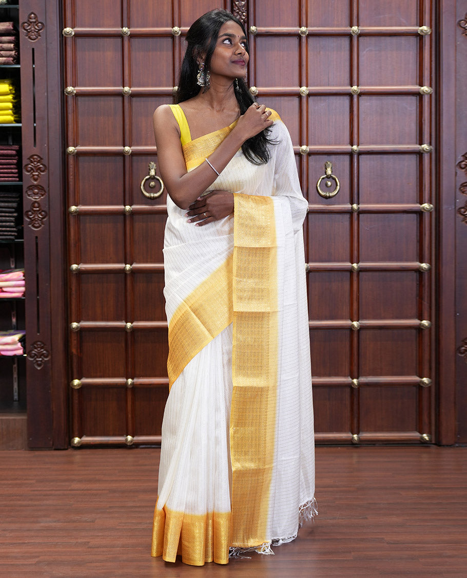 White and Yellow Dola Silk Saree Decked Up with Vertical Zari Stripes All Over the Body, Complemented by a Contrast Border of Traditional Zari Designs, Self-Pallu of Stripes, and Paired with a Contrast Blouse