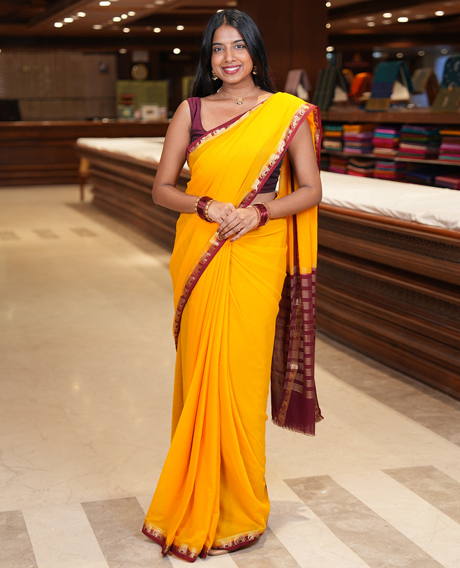 Yellow Plain Fancy Chiffon Saree, a Contrast Elephant Zari Border, Zari Striped Pallu, and a Contrast Blouse