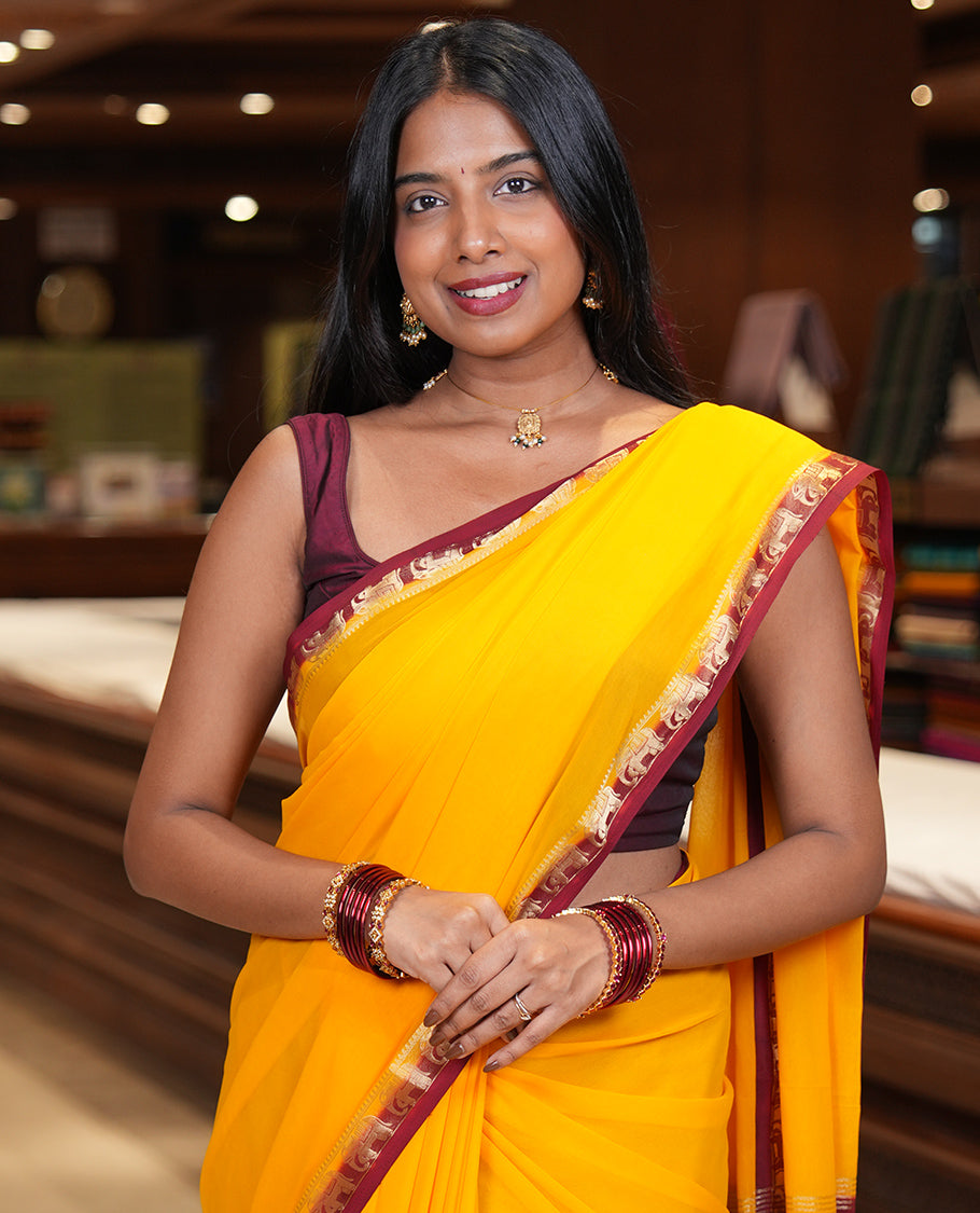 Yellow Plain Fancy Chiffon Saree, a Contrast Elephant Zari Border, Zari Striped Pallu, and a Contrast Blouse