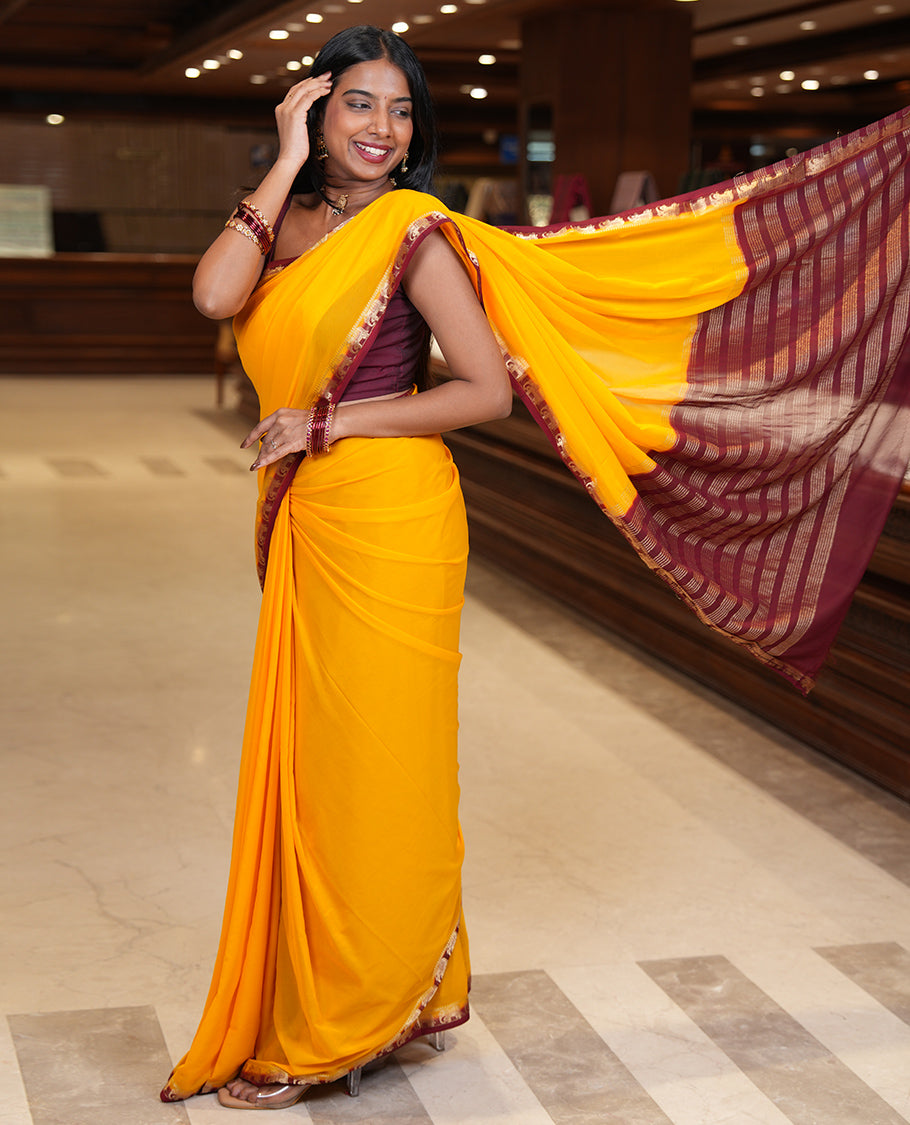 Yellow Plain Fancy Chiffon Saree, a Contrast Elephant Zari Border, Zari Striped Pallu, and a Contrast Blouse