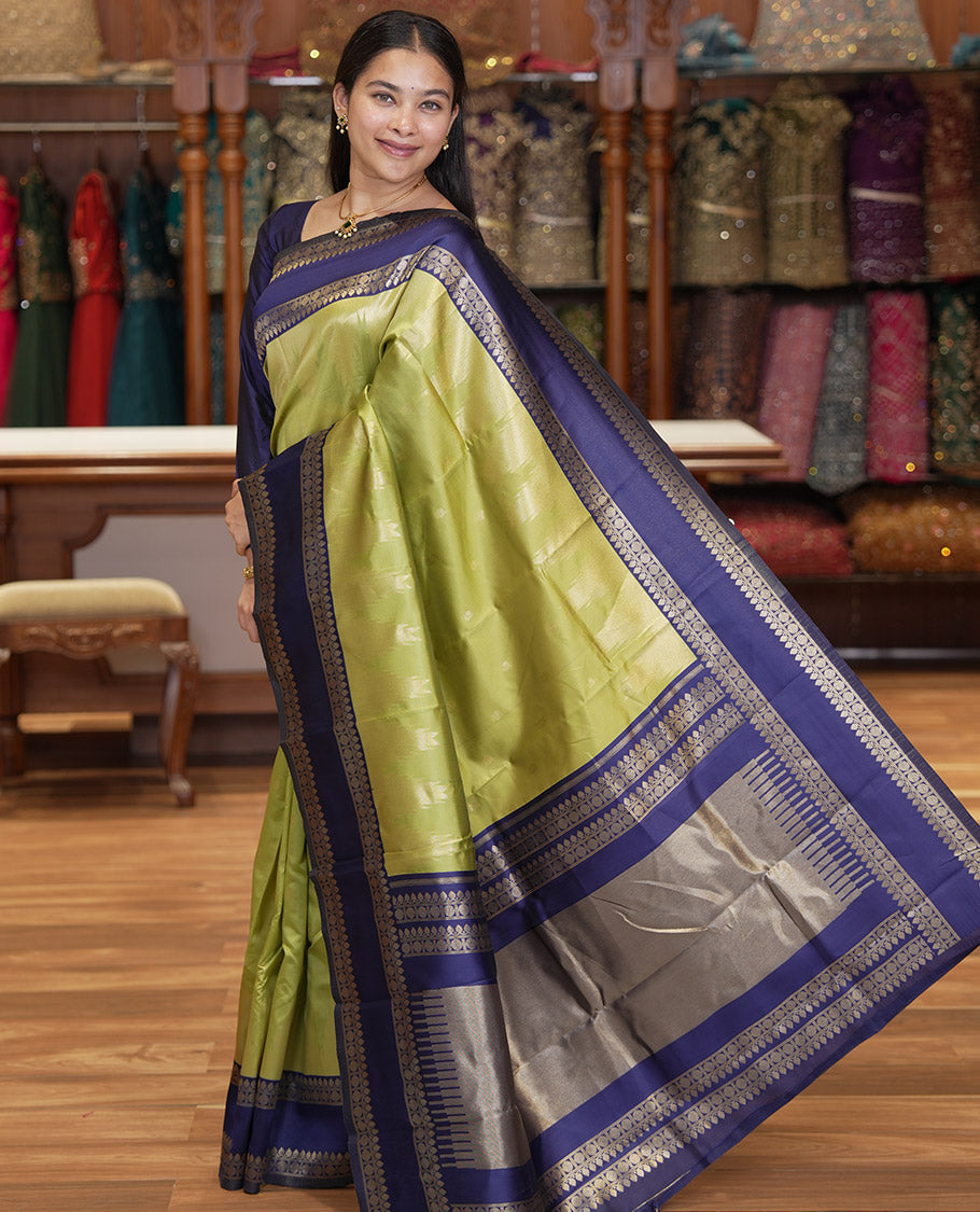 Pista Green Litchi Saree, Bedecked with Peacock Buttas , Contrast Temple Traditional Rettai Pettu Border, Pallu of Traditional , and Contrast Blouse
