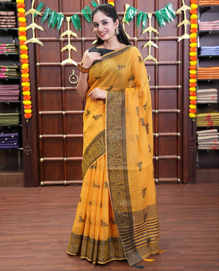 Yellow Chanderi Cotton Saree Delicately Woven with Warli Motifs All Over Its Body, Featuring a Subtly Sparkled Border Depicting Warli Village Motifs, Subtly Striped Pallu, and Paired with a Matching Blouse