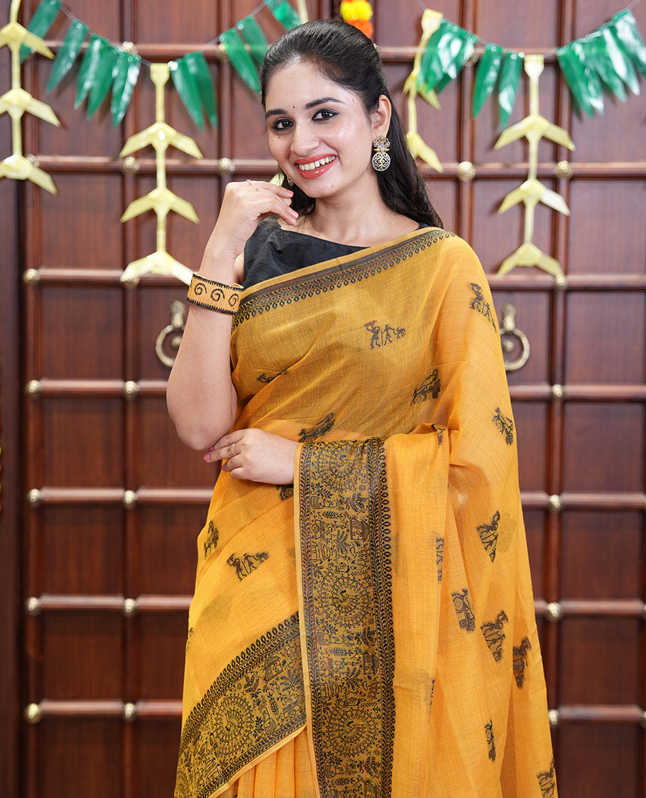 Yellow Chanderi Cotton Saree Delicately Woven with Warli Motifs All Over Its Body, Featuring a Subtly Sparkled Border Depicting Warli Village Motifs, Subtly Striped Pallu, and Paired with a Matching Blouse
