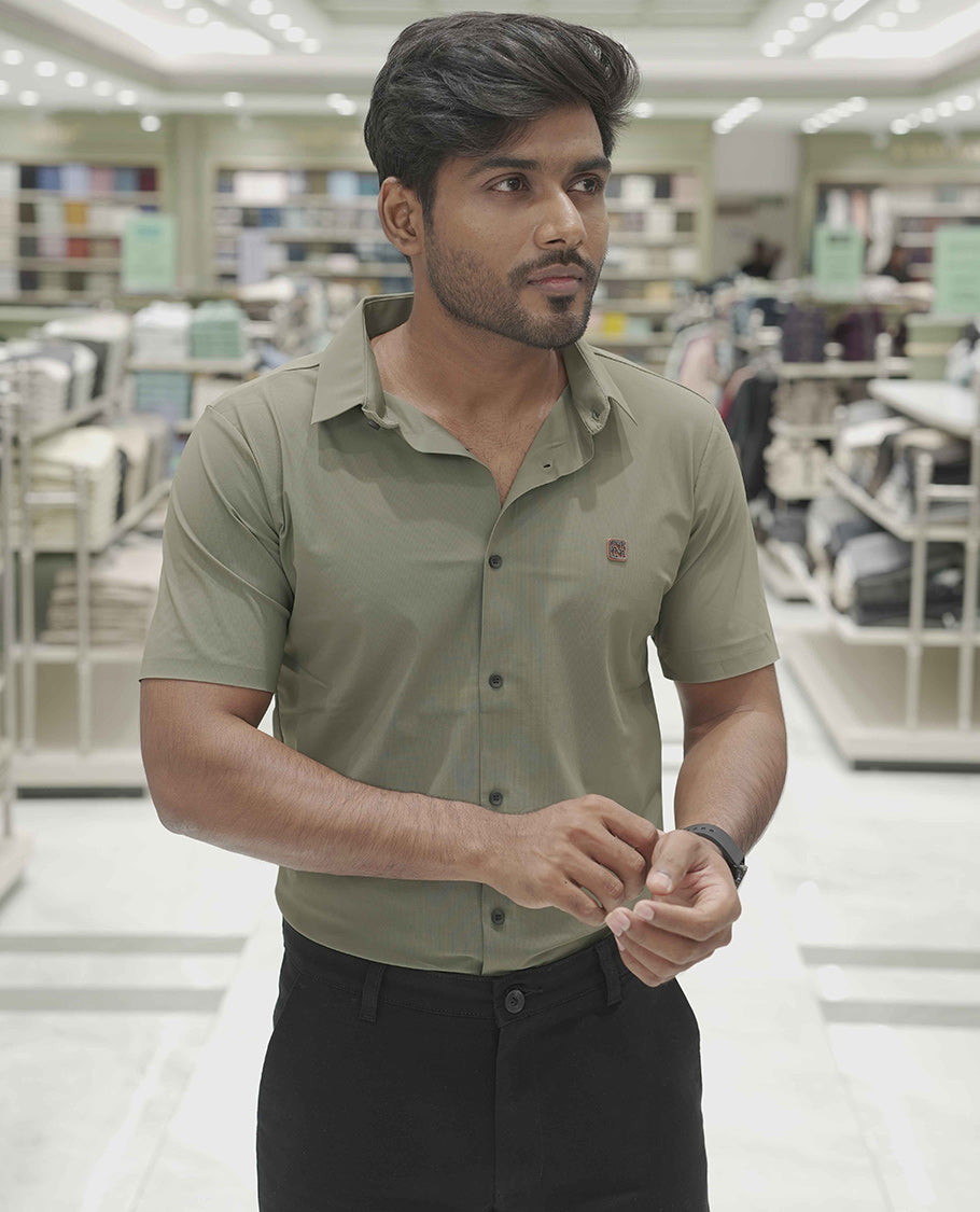 Olive Green Plain Poly Lycra Blended Casual Shirt, Comes with a Spread Collar, Stitchless Half-Sleeves, Slim Fit, and Regular Length