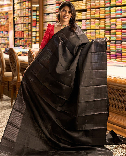 Black buttas kancheepuram silk saree with self border of thilakam mokku, muthu, banaras design & zari design pallu