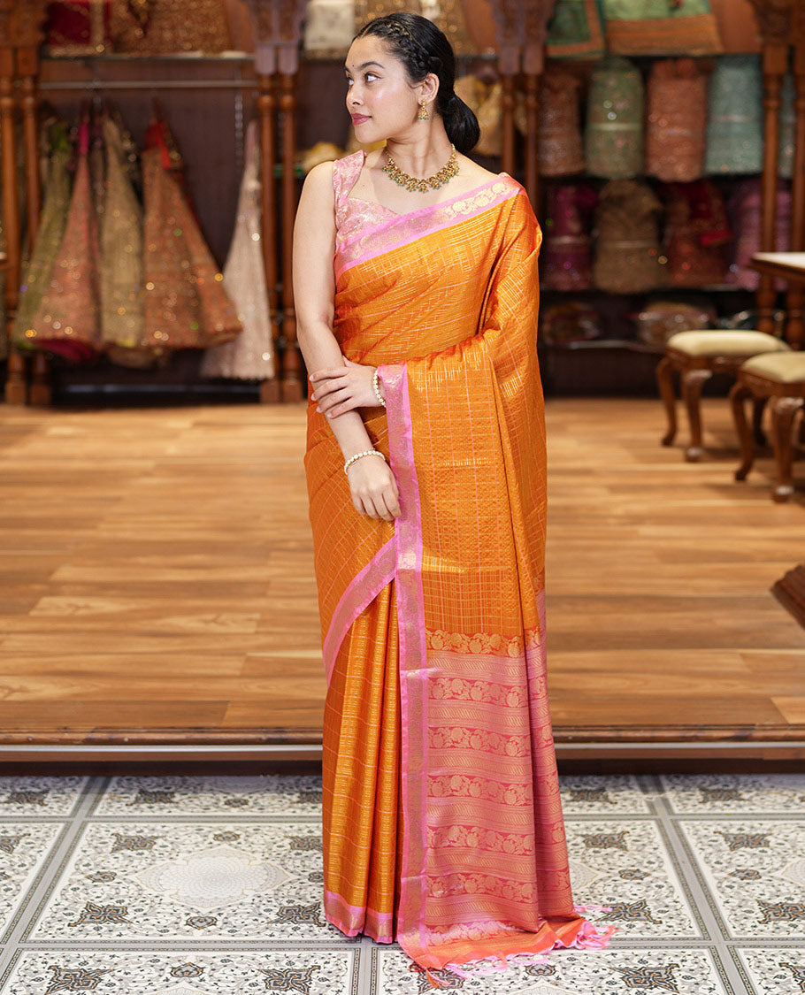 Orange Kanchipuram Budget Silk Saree, Gleamed Up with Zari Checks All Over Its Body, Complemented by a Contrast Floral Creeper Design Zari Border, Pallu Steeped with Floral Designs, and Paired with a Contrast Blouse