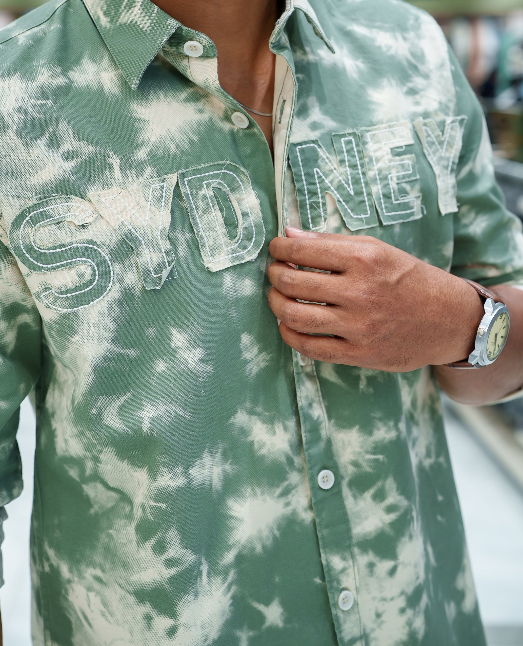 Green Cotton Blended Casual Shirt, Subtly Decked Up with Acid-Washed and Typography Patch Embroidery on the Chest, Featuring a Spread Collar, Full Sleeves, Slim Fit, and Regular Length