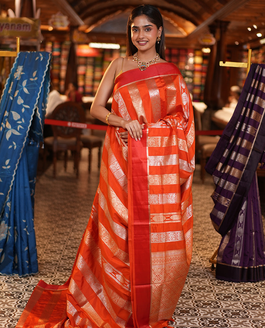 Orange Dupion Silk Saree, Richly Features Vertically Woven Traditional Patterns in Zari, Complemented by Contrast Zari Satin Border, Rich Pallu, and Paired with a Matching Blouse
