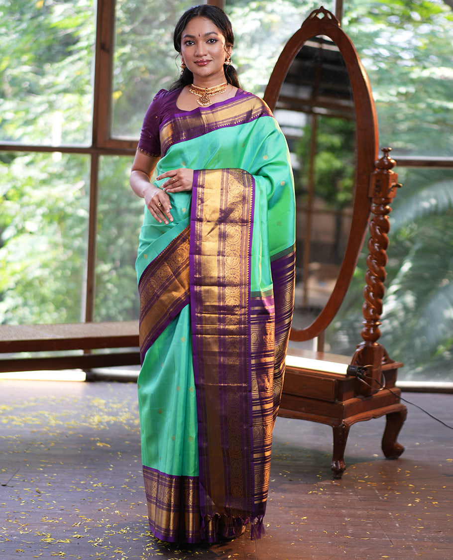Rexona Green Vasundhara Silk Saree, Beautified with Sparse Stripes and Zari Buttas, Complemented by a Contrast Border of Thilakam, Banaras, Muthu, and Round Mayil Designs, Pallu Steeped with Traditional Designs, and Paired with a Contrast Blouse