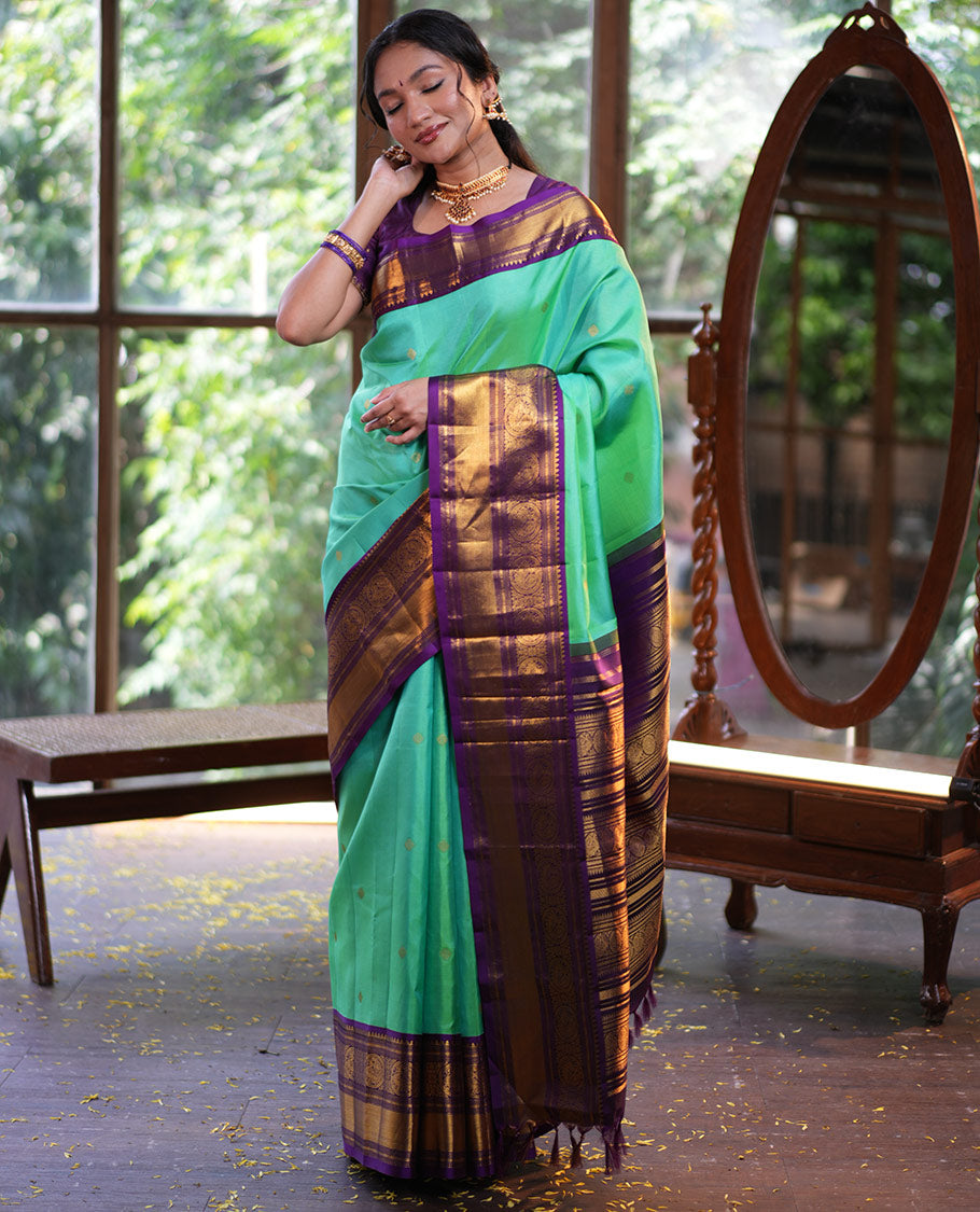 Rexona Green Vasundhara Silk Saree, Beautified with Sparse Stripes and Zari Buttas, Complemented by a Contrast Border of Thilakam, Banaras, Muthu, and Round Mayil Designs, Pallu Steeped with Traditional Designs, and Paired with a Contrast Blouse