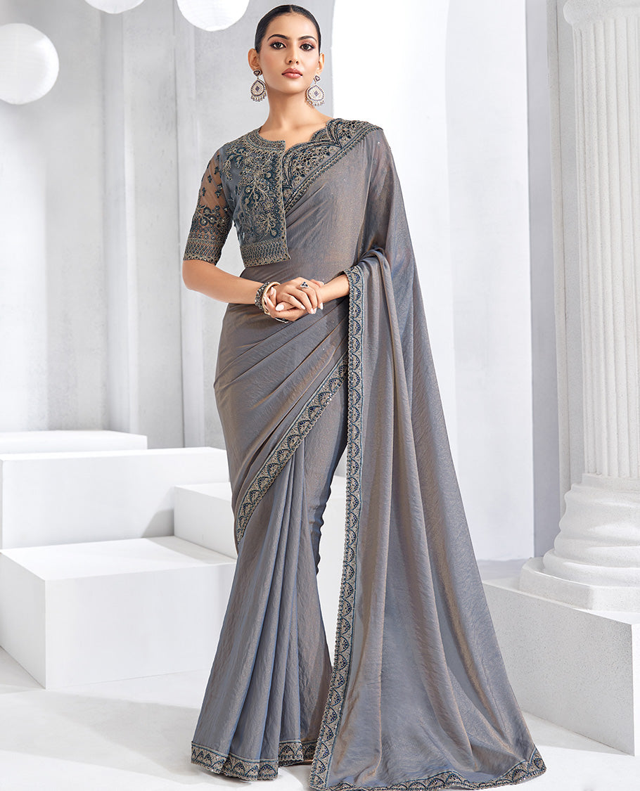 Grey plain designer saree, scallop embroidered border, self-pallu, and a heavy embroidered jacket blouse