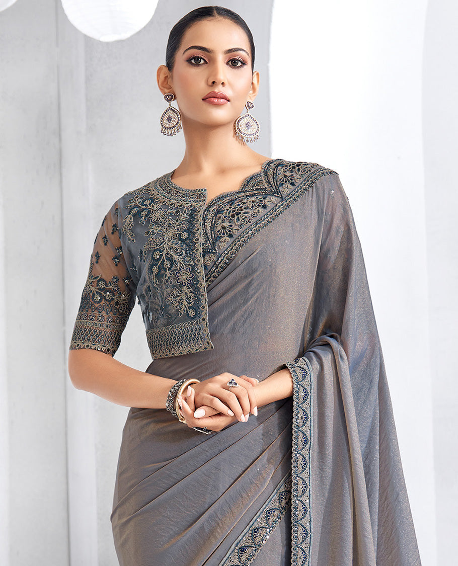 Grey plain designer saree, scallop embroidered border, self-pallu, and a heavy embroidered jacket blouse