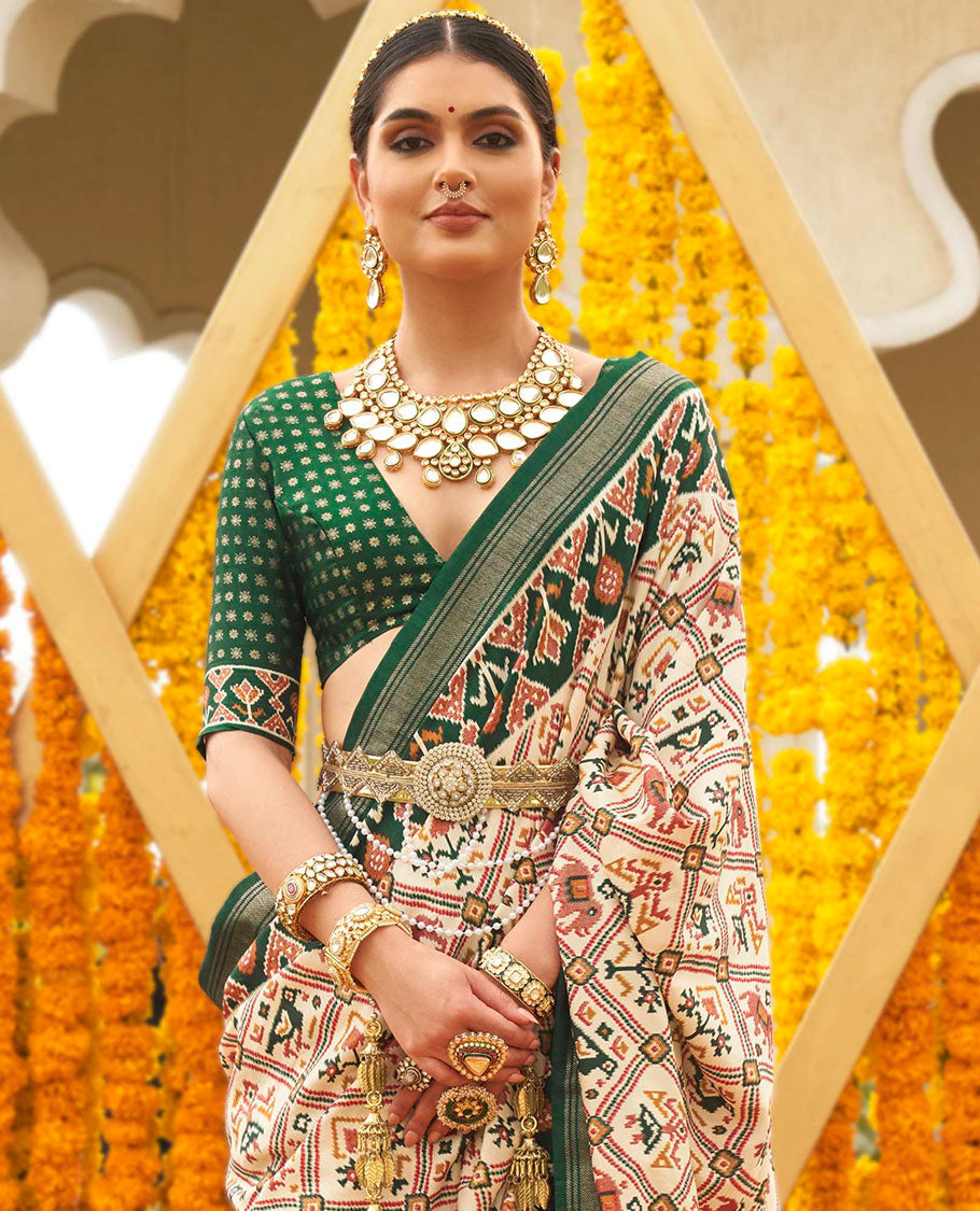 Light sandal base butta enclosed jaal patola printed designer saree, contrast ikkat border, and floral ikkat design pallu