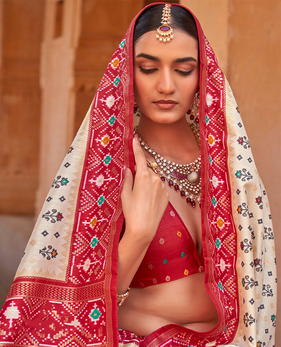 Light Sandal Ikat Patola Designer Saree, Accentuated with Floral Ikat Buttas, Complemented by a Contrast Ikat Border, Intricate Pallu, and a Contrast Blouse