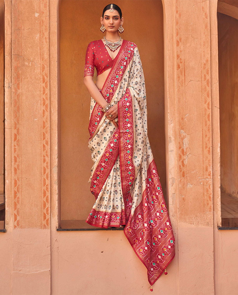 Light Sandal Ikat Patola Designer Saree, Accentuated with Floral Ikat Buttas, Complemented by a Contrast Ikat Border, Intricate Pallu, and a Contrast Blouse