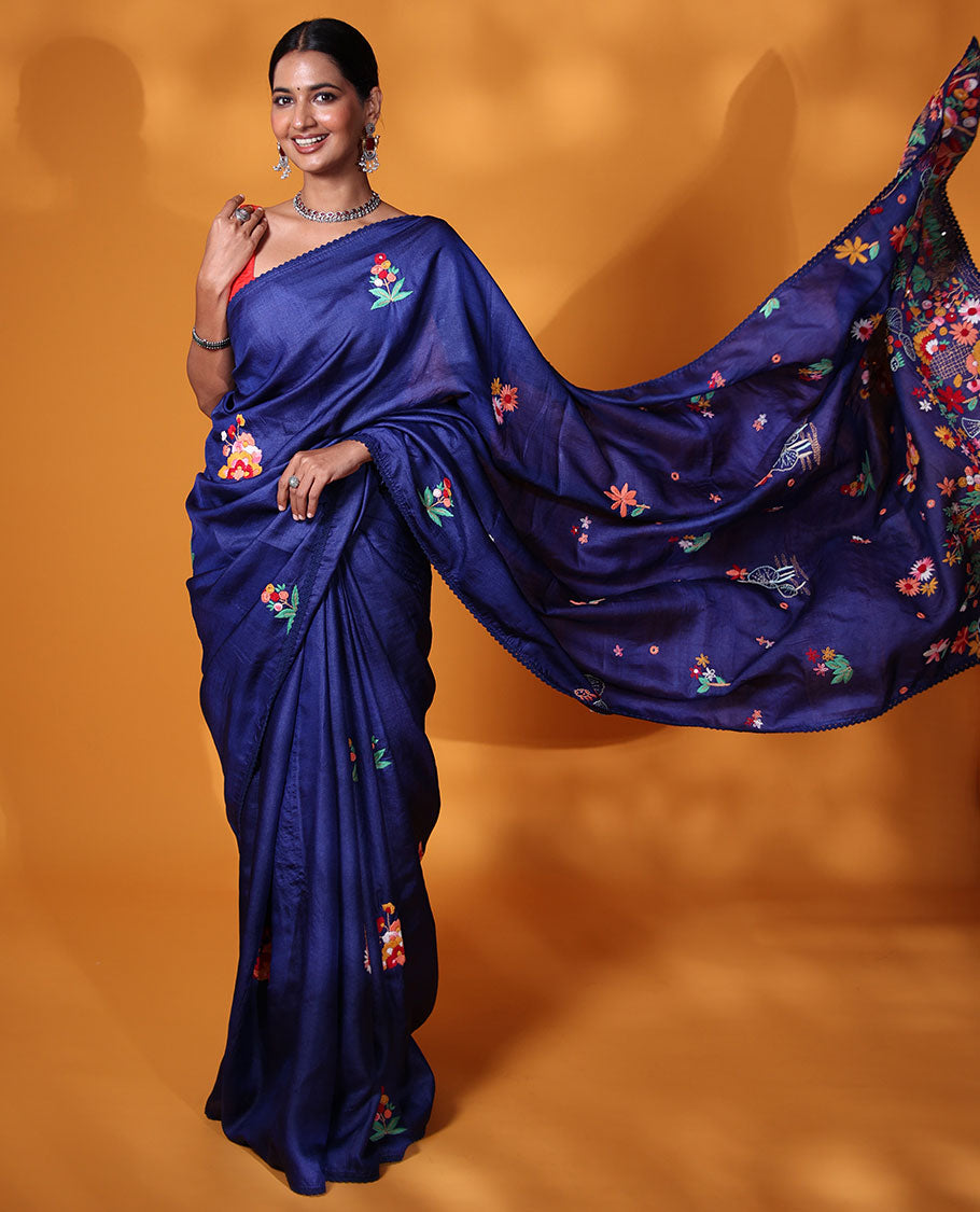 Borderless ink blue base tussar saree with kaleidoscopic-colored thread floral embroidery motifs