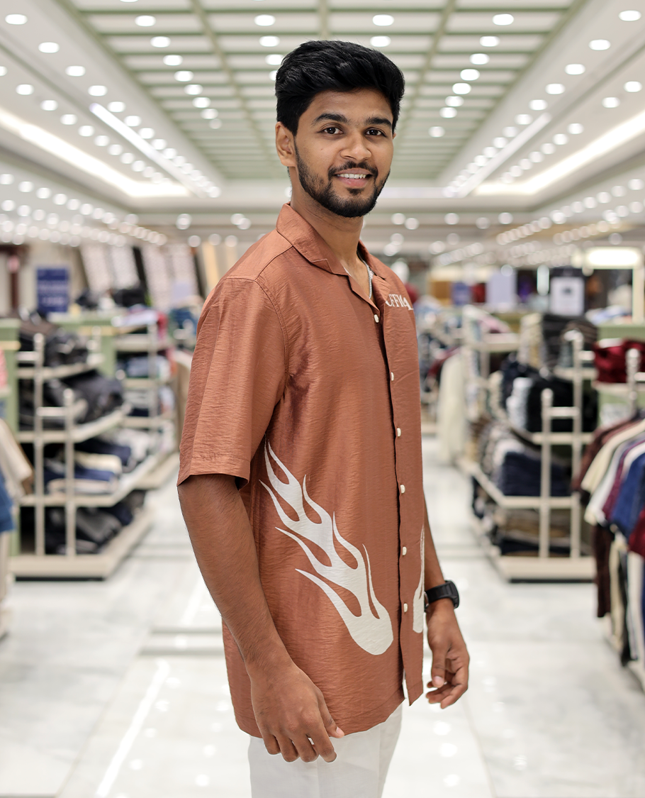 Brown Poly-Blended Causal Shirt, Comes with Fire Motifs Print, Half Sleeves, a Cuban Collar, a Boxy Fit, and Regular Length