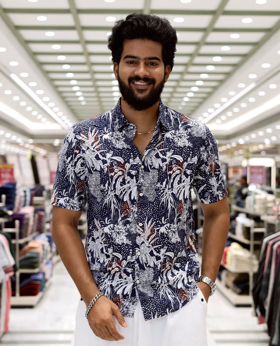 Blue Cotton-Blended Casual Shirt, Decked Up with Tropical Floral Print, Half Sleeves, a Regular Fit, a Spread Collar, and Regular Length