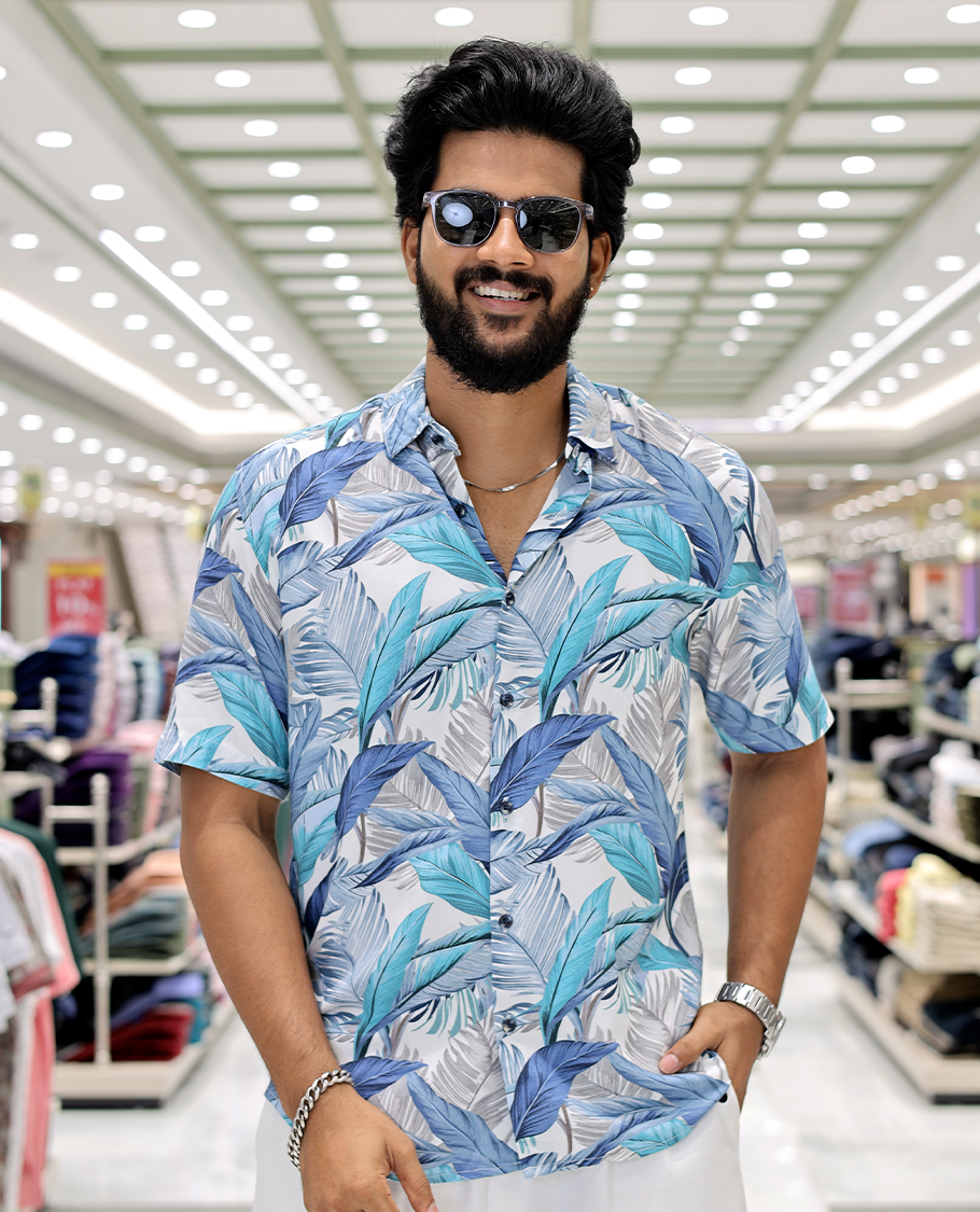 Blue Cotton-Blended Casual Shirt, Elevated with Tropical Floral Print, Half Sleeves, a Regular Fit, a Spread Collar, and Regular Length