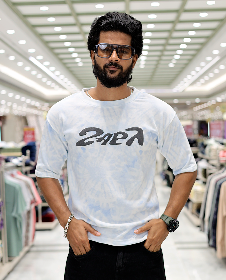 Light Blue Oversized Cotton-Blended T-Shirt Features an Abstract Dyed Typography Print, Half-Sleeves, Crew Neck, and Regular Length