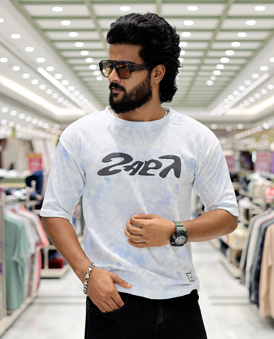 Light Blue Oversized Cotton-Blended T-Shirt Features an Abstract Dyed Typography Print, Half-Sleeves, Crew Neck, and Regular Length