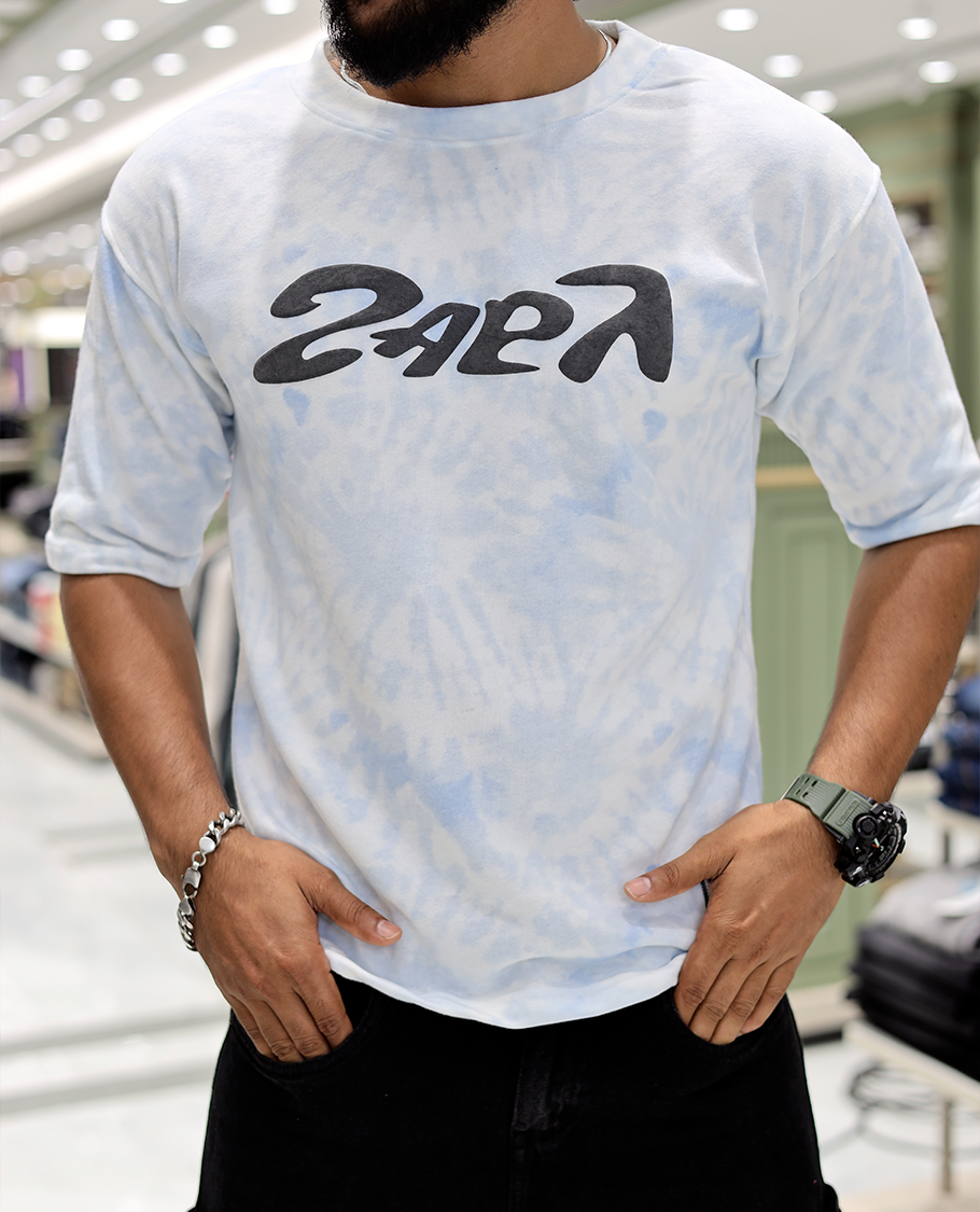 Light Blue Oversized Cotton-Blended T-Shirt Features an Abstract Dyed Typography Print, Half-Sleeves, Crew Neck, and Regular Length