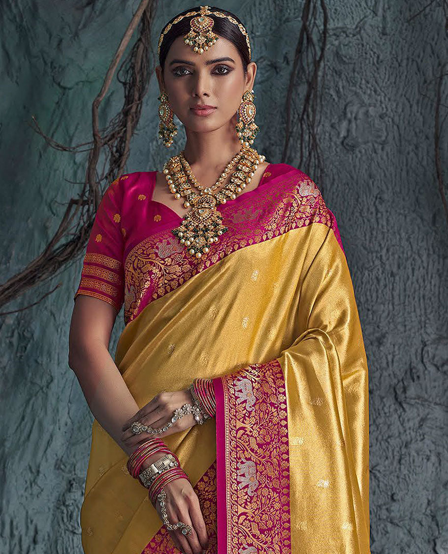 Gold Designer Saree, Subtly Sparkled with Buttas All Over Its Body, Complemented by a Contrast Floral and Elephant Border, Pallu of Intricate Designs, and Paired with a Contrast Blouse