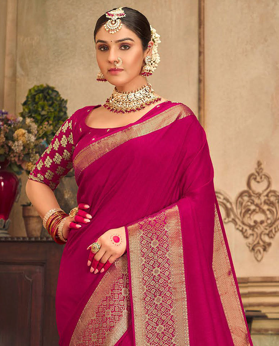 Magenta plain designer saree, patola-style motifs woven border, and zari striped pallu