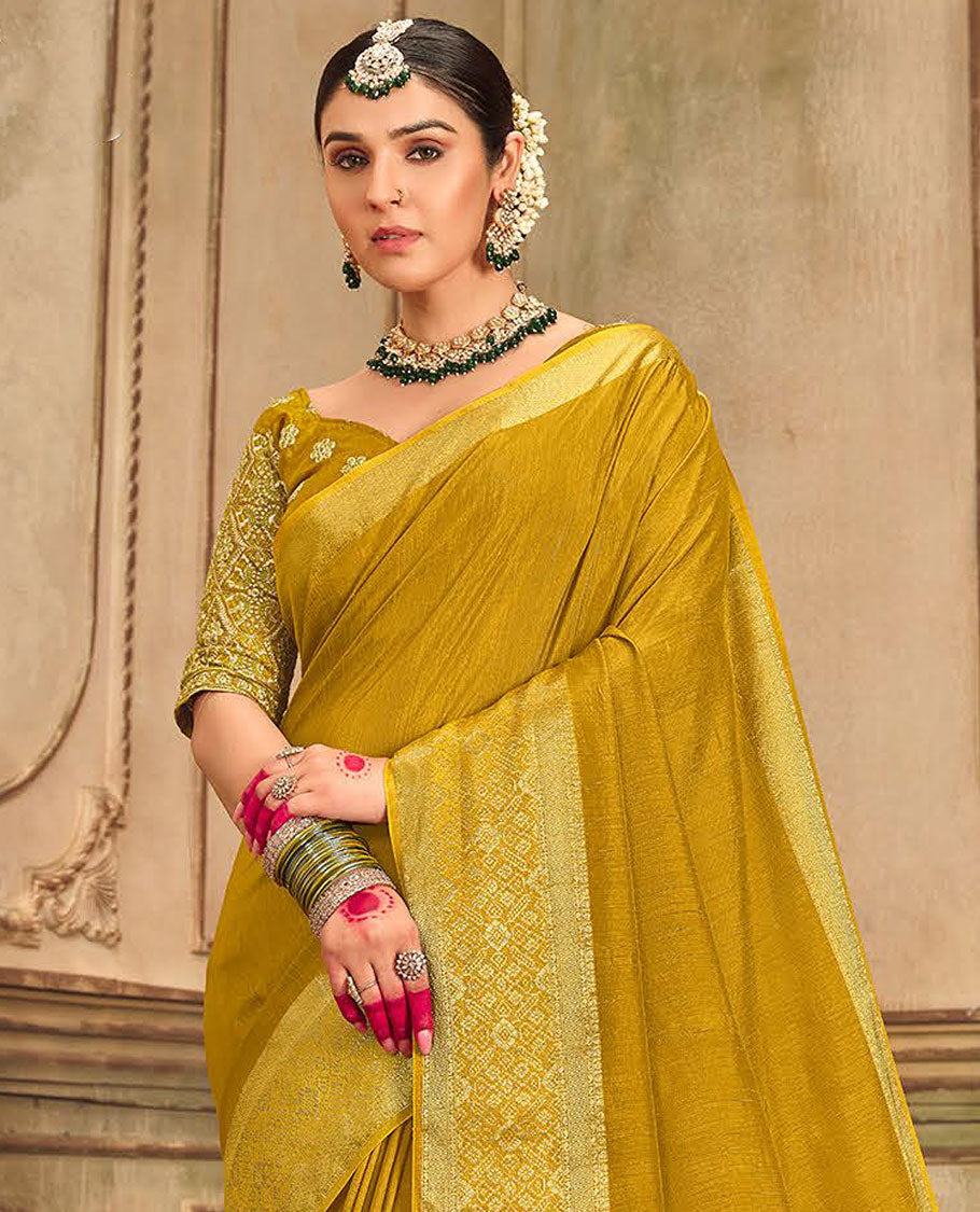 Mustard plain designer saree, patola-style motifs woven border, and zari striped pallu