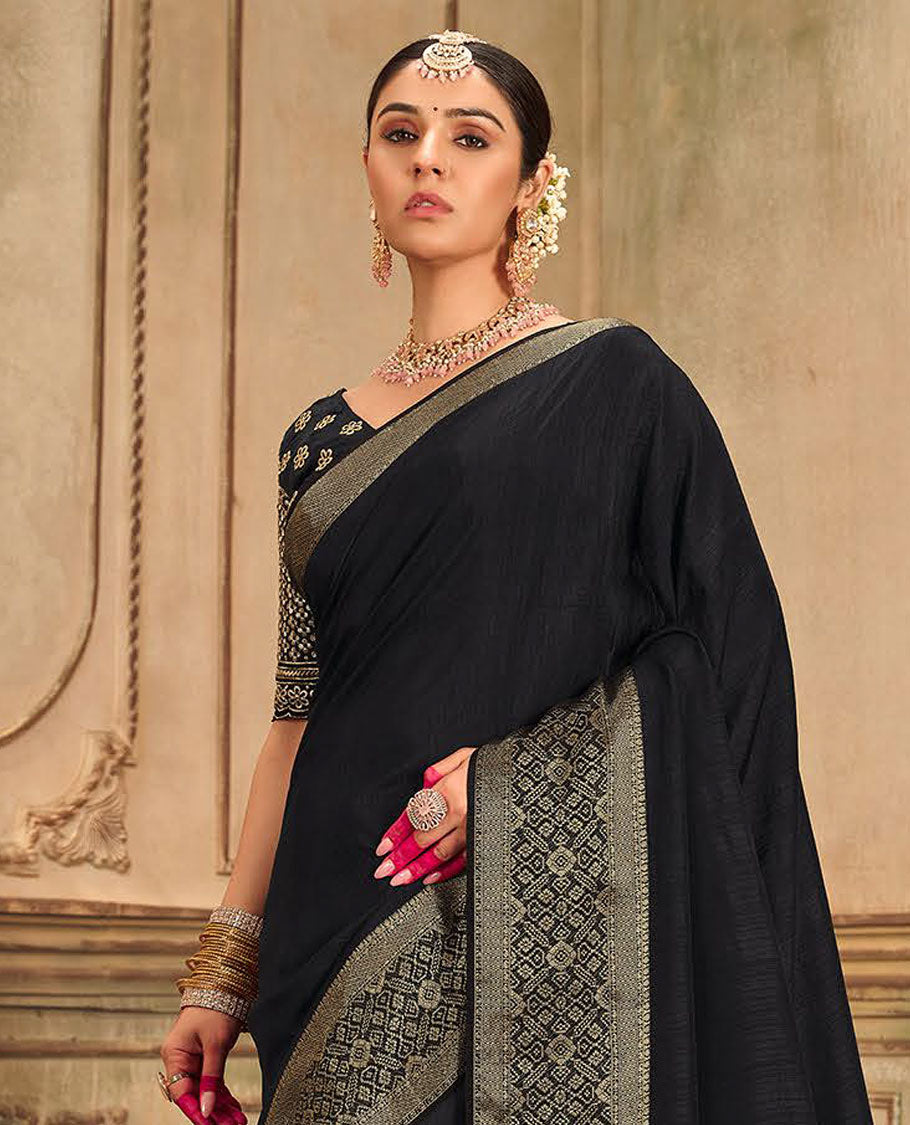Black plain designer saree, patola-style motifs woven border, and zari striped pallu