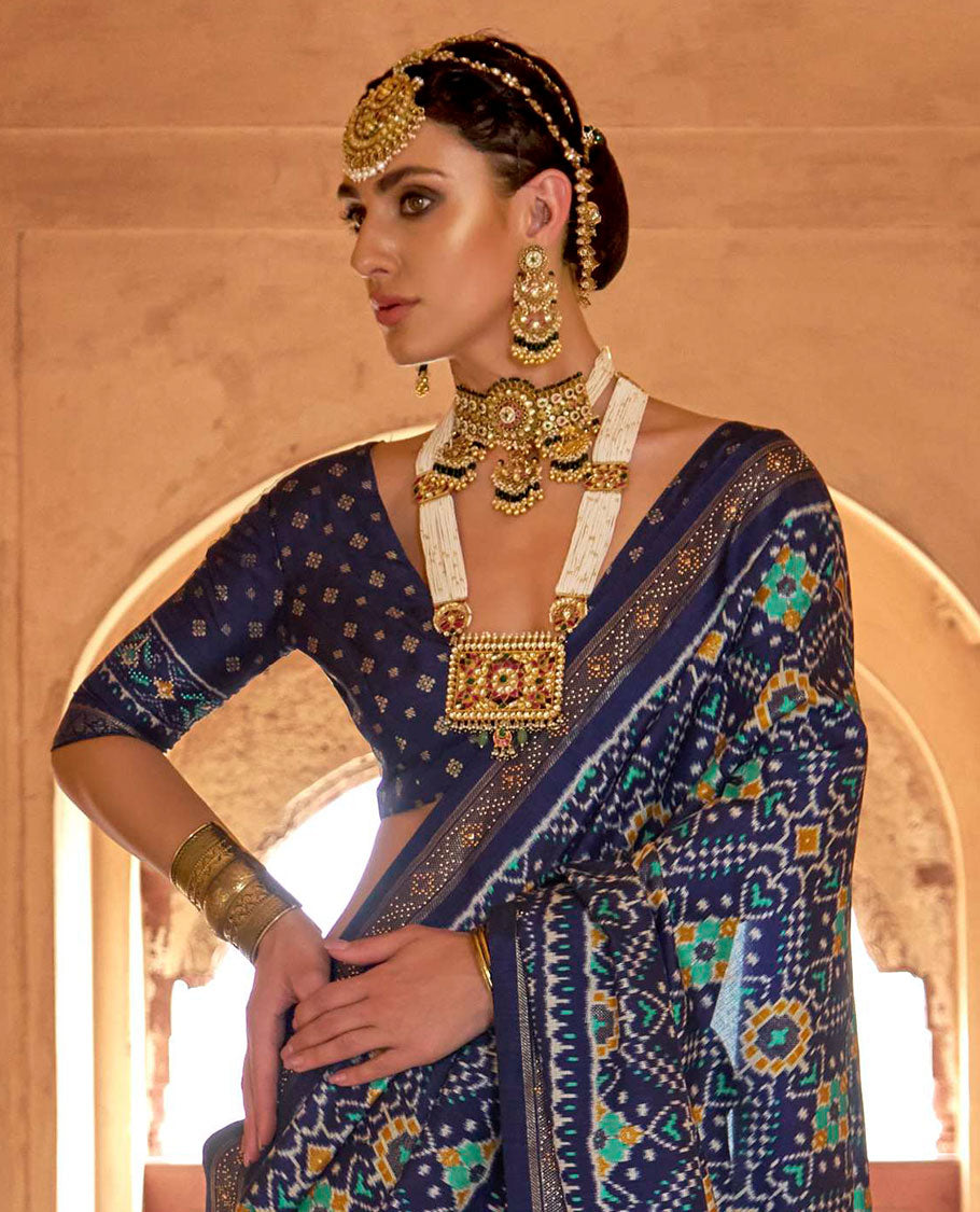 Blue double-ikkat patola printed designer catalog saree, stone work border, and patola patterned pallu