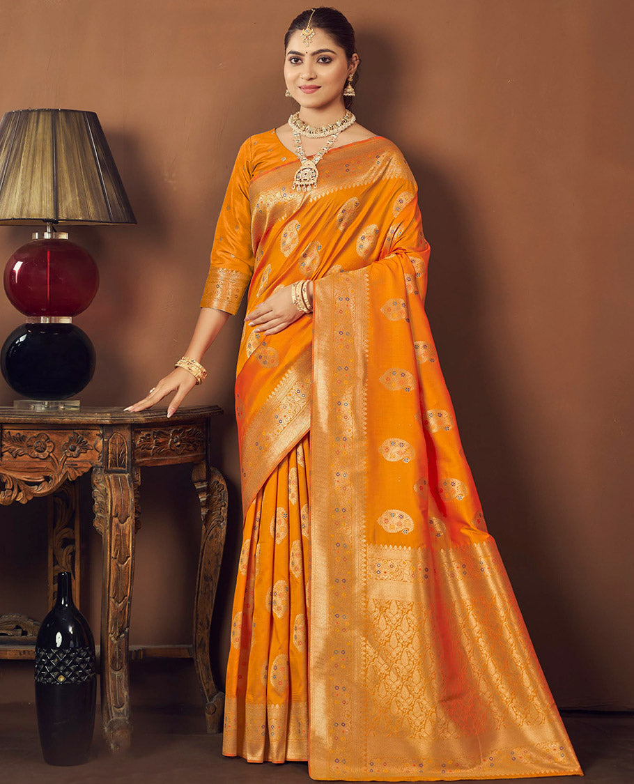 Orange Banaras Designer Catalog Saree, Ornamented with Paisley Meena Buttas, Highlighted by a Traditional Meenakari Border, Grand Pallu, and a Matching Blouse
