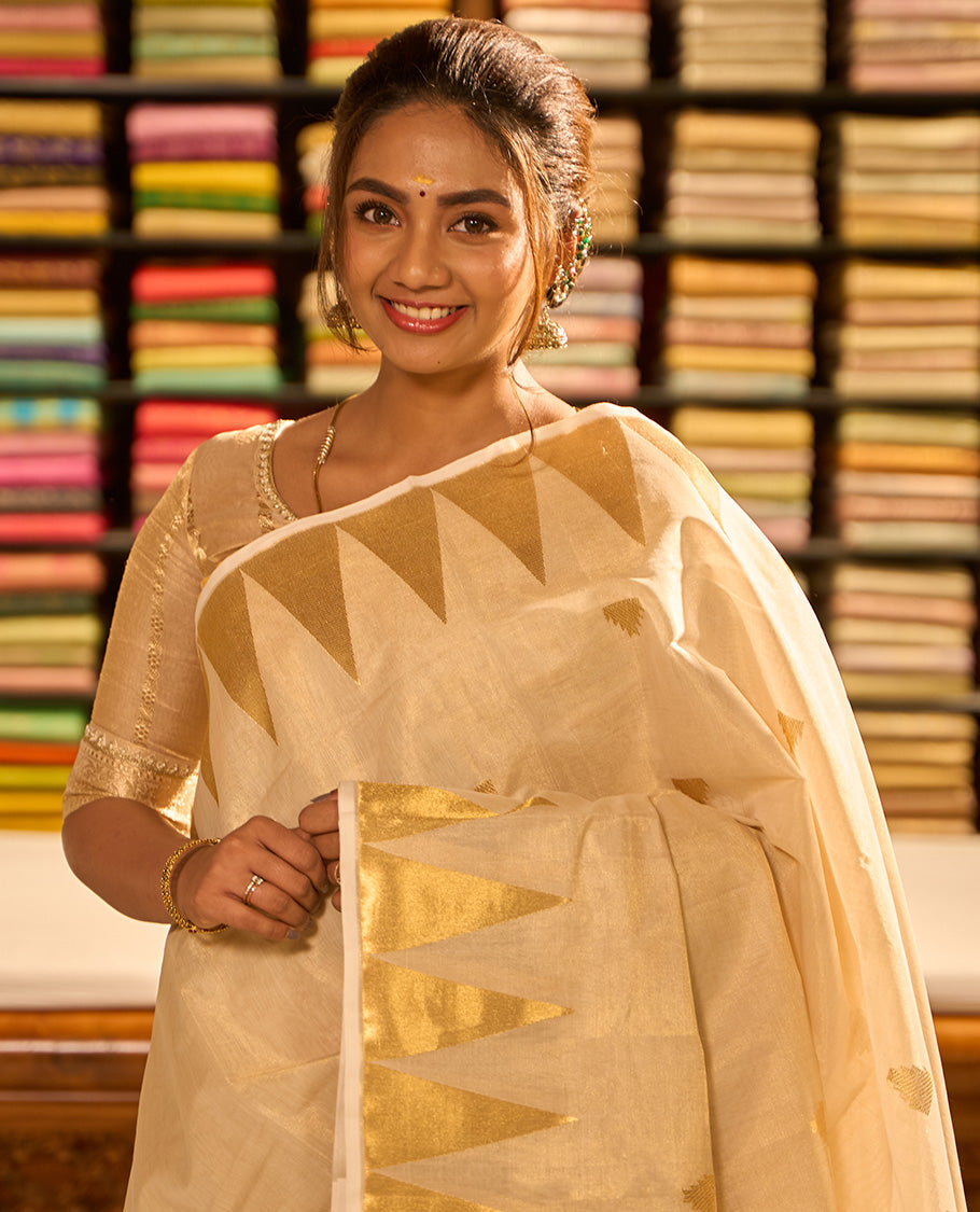 Cream triangle motifs kasavu saree with self temple border & gold zari striped pallu
