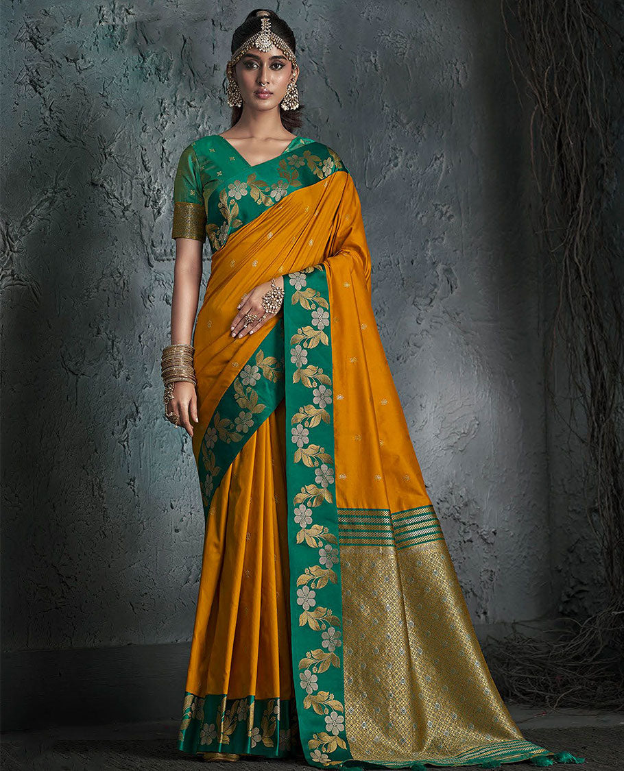 Orange Designer Saree, Featuring Buttas on Its Body, Complemented by a Contrast Border of Floral Creeper Designs, Pallu of Intricate Zari Designs, and Paired with a Contrast Blouse