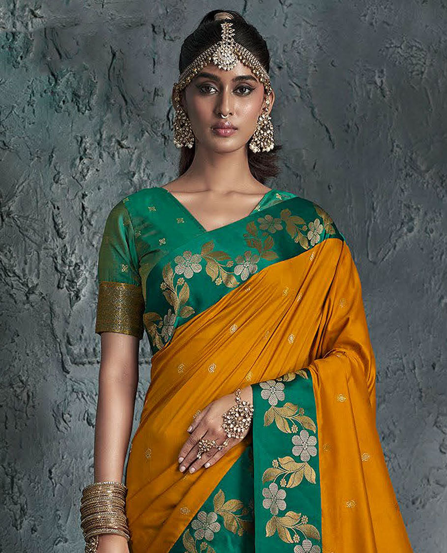 Orange Designer Saree, Featuring Buttas on Its Body, Complemented by a Contrast Border of Floral Creeper Designs, Pallu of Intricate Zari Designs, and Paired with a Contrast Blouse