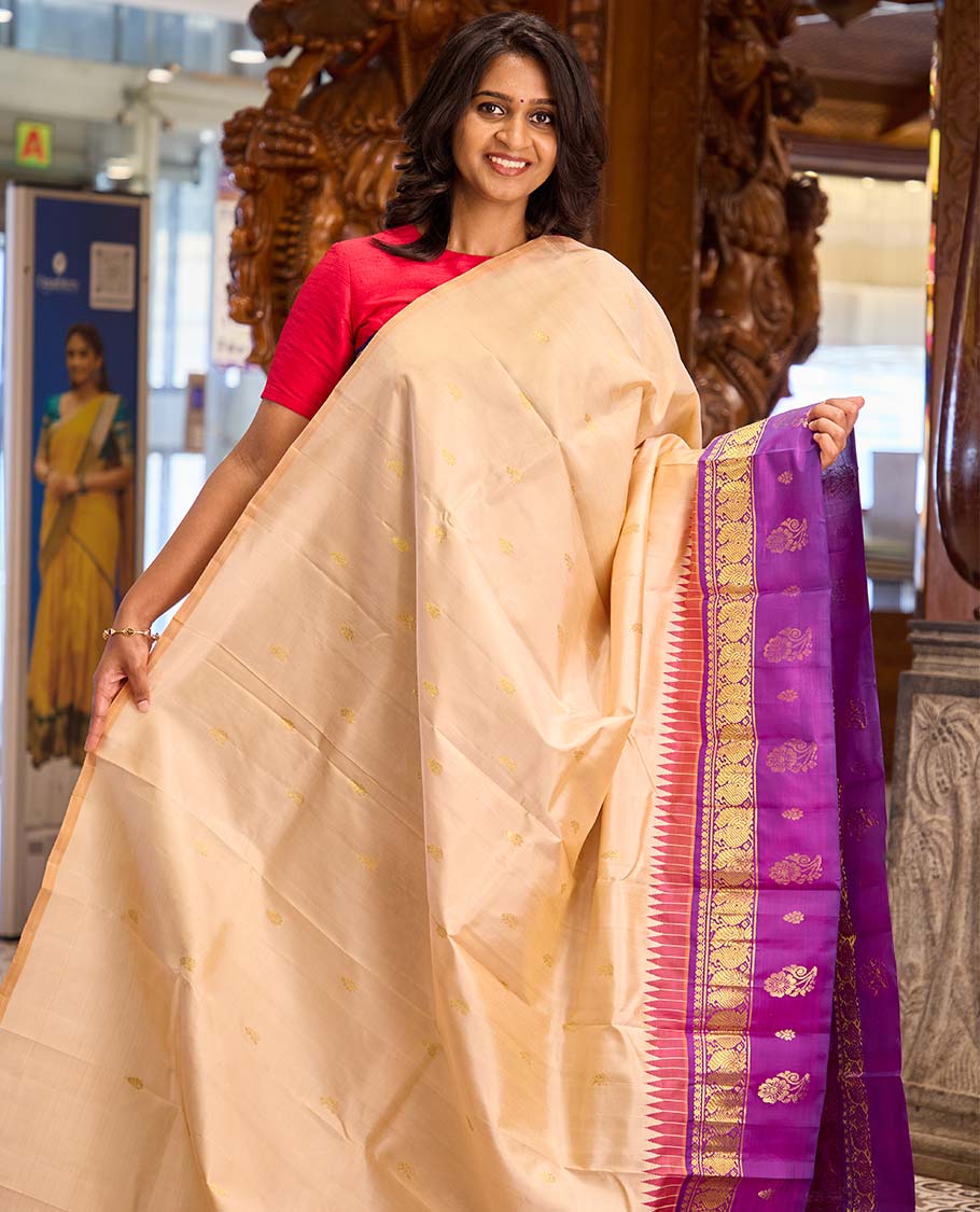 Sandal zari buttas Kanchipuram silk saree, contrast one-sided thazampoo rekku border of thilakam mokku and mayil zari motifs, and zari woven pallu
