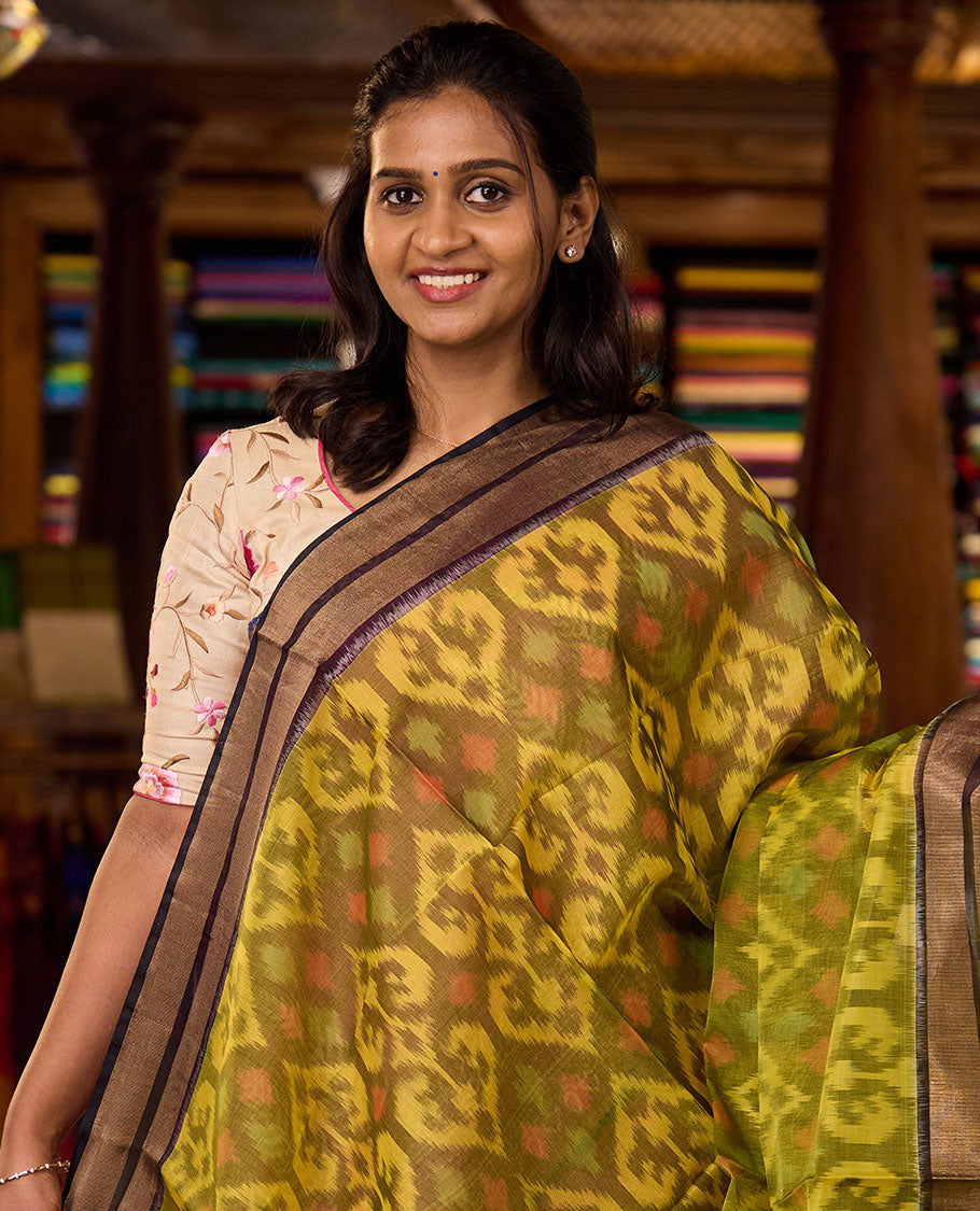 Green Pochampally Ikkat-style ogee patterned silk cotton saree, contrast bavanji zari border, and ikkat design pallu