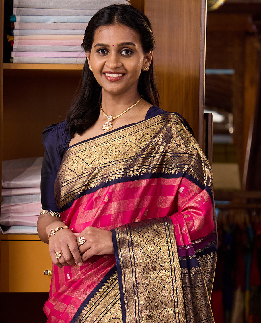 Pink zari buttas and checked Kanchipuram silk saree, contrast border of thazampoo rekku, kathir, mayil kann, and jaal designs