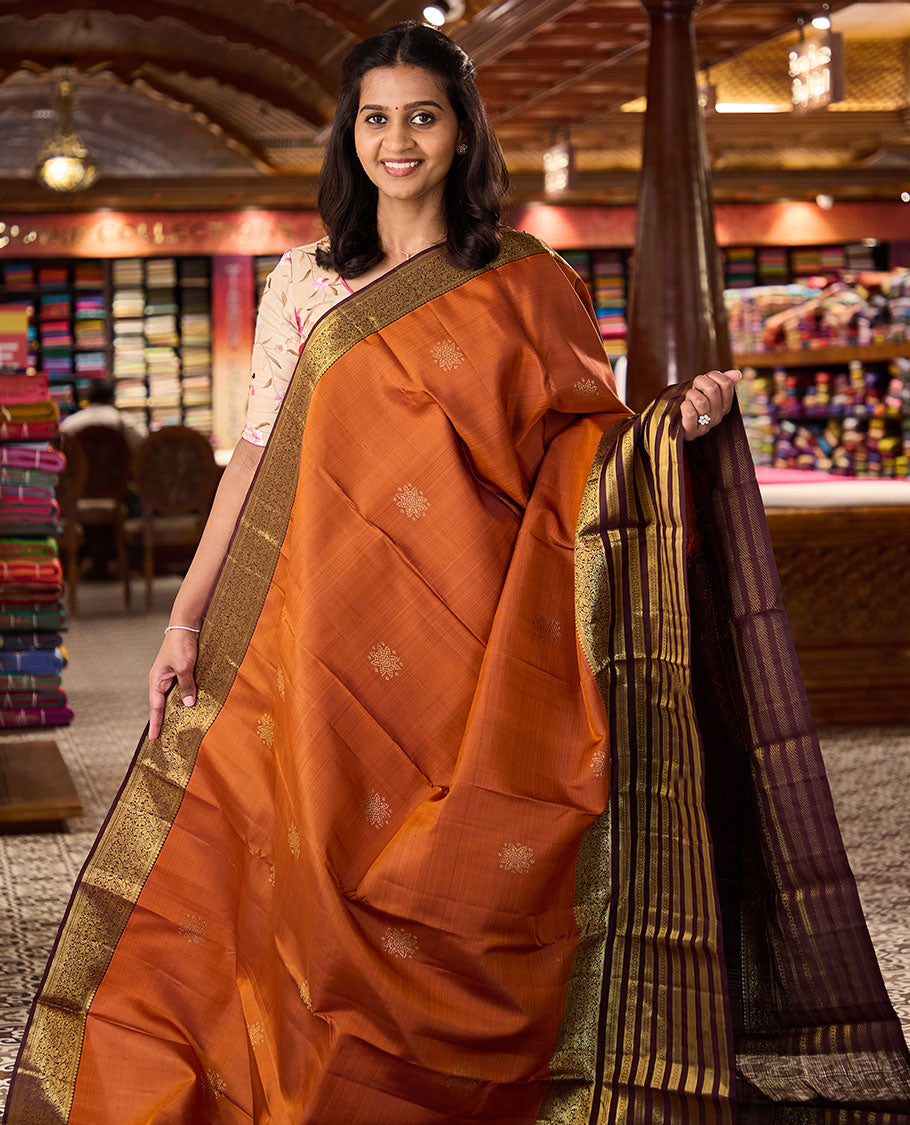 Orange zari buttas Kanchipuram silk saree, contrast varisai pettu border of thilakam mokku, banaras, muthu, kodi visiry, and mayil designs, and jaal pallu