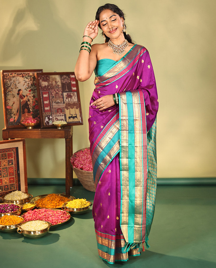 Purple Vasundhara Silk Saree, Beautifully Bedecked with Kamalam Buttas on Its Body, Complemented by a Captivating Contrast Border of Muthu, Chakram, and Mayil Kann Designs, Grand Jaal Pallu, and Paired with a Contrast Blouse