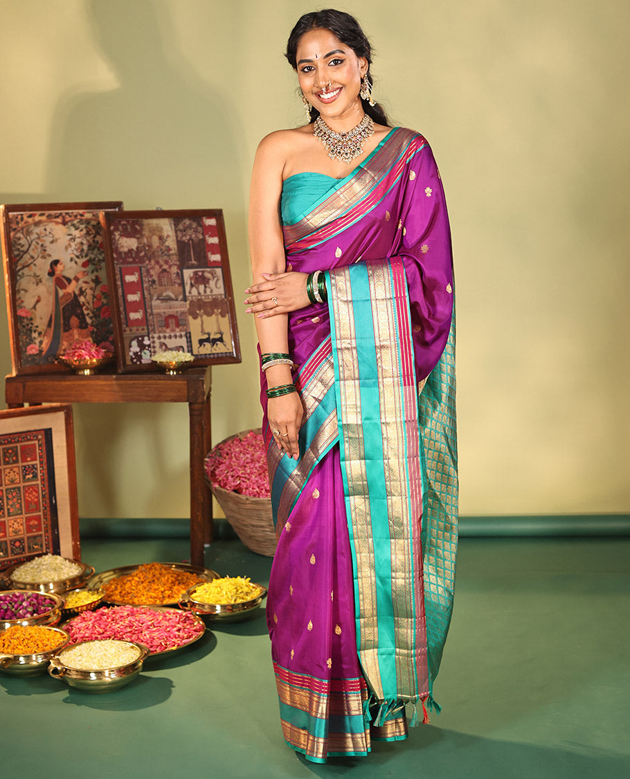 Purple Vasundhara Silk Saree, Beautifully Bedecked with Kamalam Buttas on Its Body, Complemented by a Captivating Contrast Border of Muthu, Chakram, and Mayil Kann Designs, Grand Jaal Pallu, and Paired with a Contrast Blouse