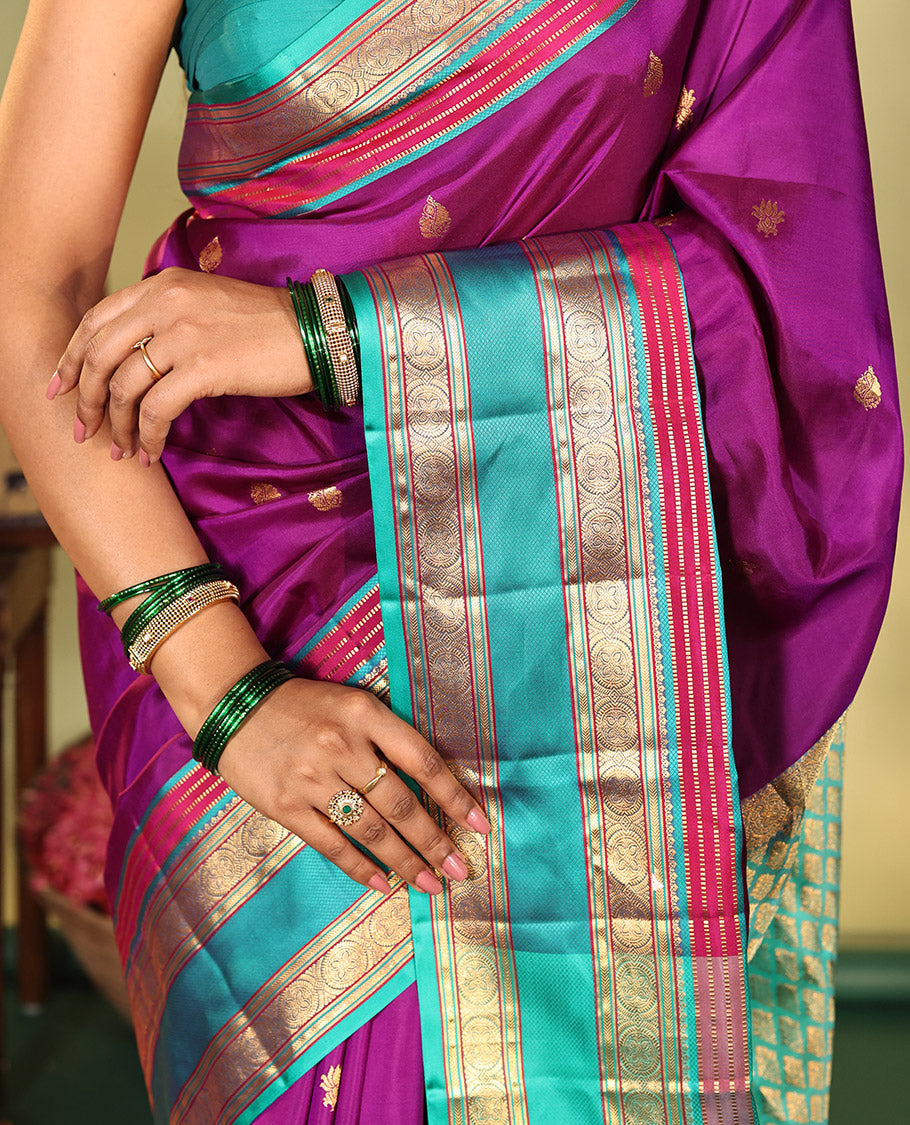 Purple Vasundhara Silk Saree, Beautifully Bedecked with Kamalam Buttas on Its Body, Complemented by a Captivating Contrast Border of Muthu, Chakram, and Mayil Kann Designs, Grand Jaal Pallu, and Paired with a Contrast Blouse