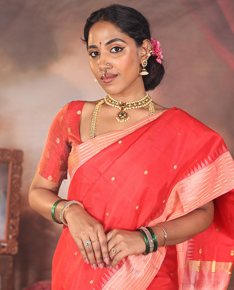 Red Vasundhara Silk Saree, Gracefully Woven with Kamalam Buttas on Its Body, Complemented by a Captivating Contrast Thazampoo Rekku Border of Banaras Designs, Zari-Decked Up Pallu, and Paired with a Contrast Blouse