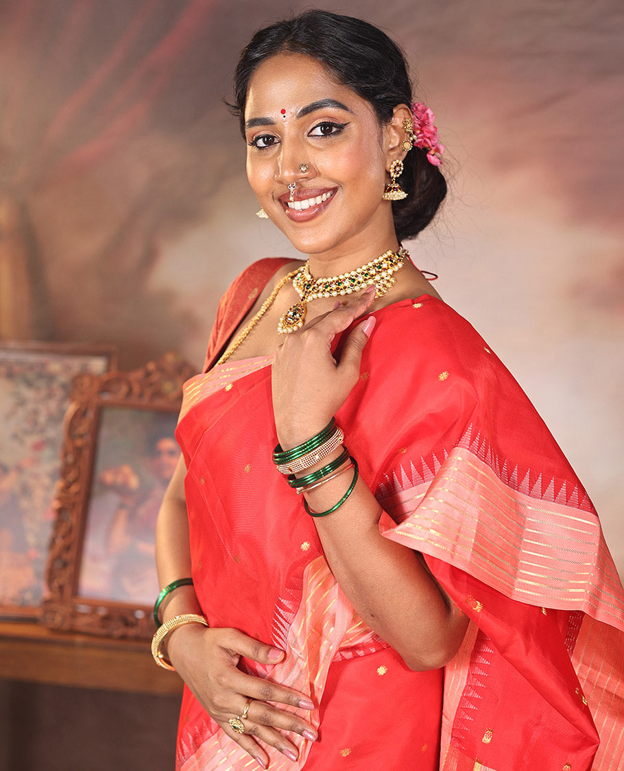 Red Vasundhara Silk Saree, Gracefully Woven with Kamalam Buttas on Its Body, Complemented by a Captivating Contrast Thazampoo Rekku Border of Banaras Designs, Zari-Decked Up Pallu, and Paired with a Contrast Blouse