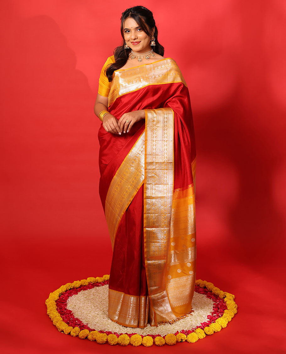 Red plain Kanchipuram silk saree, contrast korvai border of muthu, vanki, neli, rudraksham, and mayil kann, and traditional zari steeped pallu