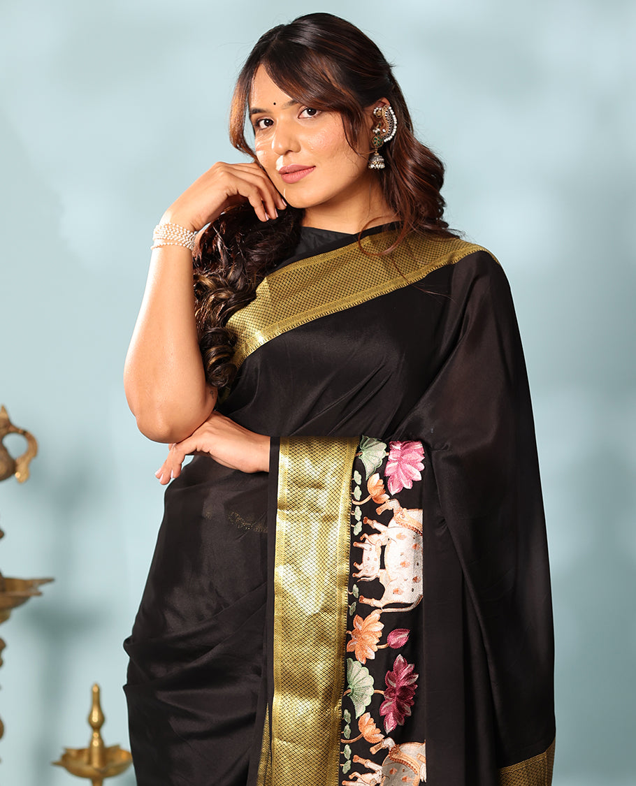 Black delicately thread hand embroidered Mysore silk saree features Pichwai lotus vine, and cow motifs, traditional zari border, and jaal pallu